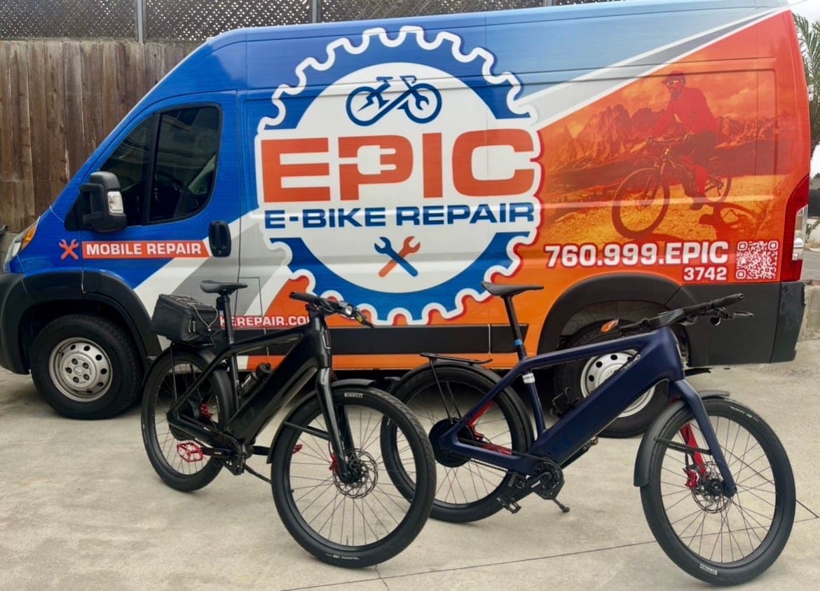 Expert Stromer repair — two Stromer e-bikes beside the Epic E-Bike Repair mobile van